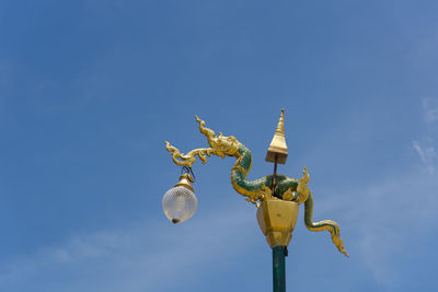 Low angle view of a bird against sky