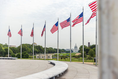 Flag against sky in city