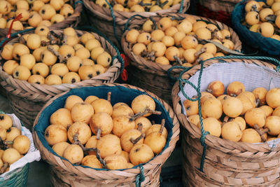 High angle view of fruits for sale at market stall loquat