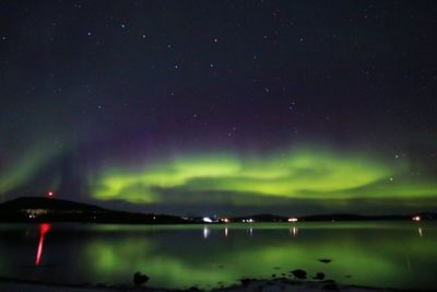 Scenic view of lake against sky at night