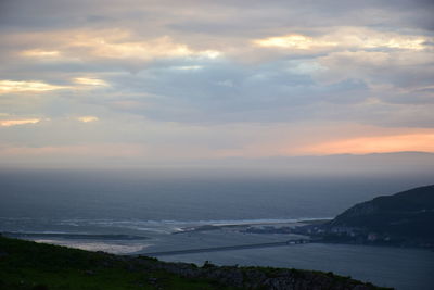 View of calm sea against cloudy sky