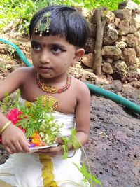 Portrait of cute girl holding plant