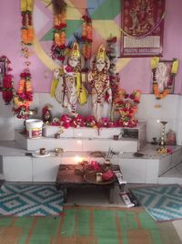 Multi colored illuminated candles on table in temple