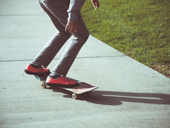 Low section of person standing on road