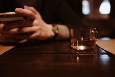 Close-up of a man sitting on table