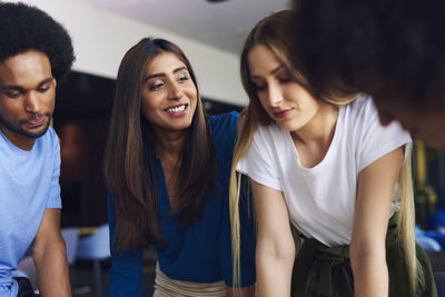 Colleagues discussing during meeting in office