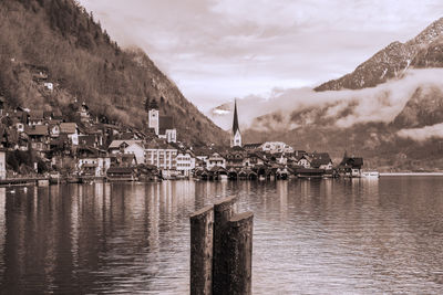 Scenic view of lake by buildings against sky