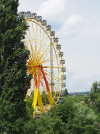 Low angle view of ferris wheel against sky