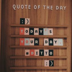 Close-up of text on wooden shelf