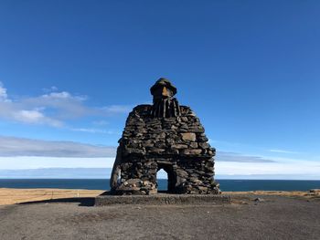 Statue of rock formations at seaside