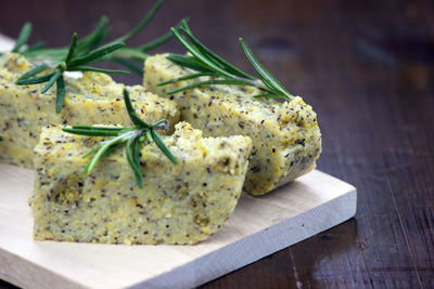 Close-up of sliced polenta with cheese and rosemary