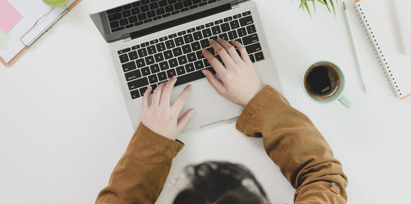 High angle view of man using laptop on table