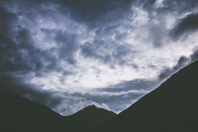 Low angle view of silhouette mountain against sky