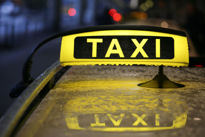 Close-up of yellow sign on car