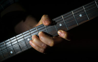 Close-up of hands playing guitar