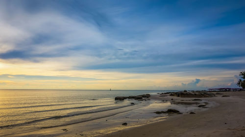 Scenic view of beach against sky during sunset