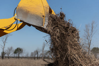 Low angle view of windmill against sky