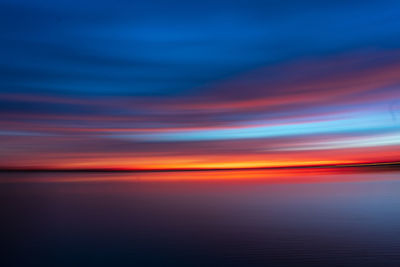 Scenic view of sea against romantic sky at sunset