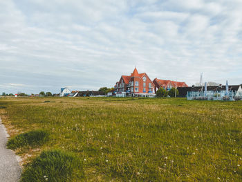 Houses on field against sky