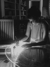 Woman sitting on table at home