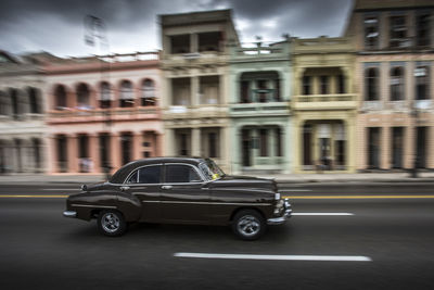 Car on road against buildings