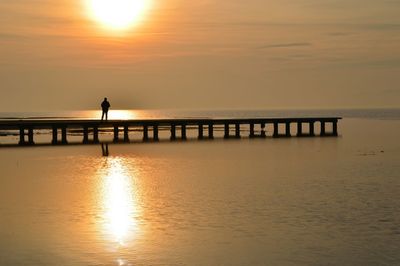 Silhouette of person on beach at sunset