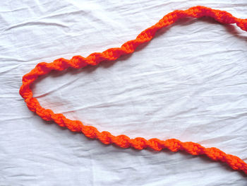 Close-up of orange paper on bed