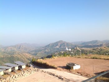 Scenic view of landscape and mountains against clear blue sky