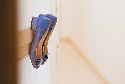 Close-up of shoes hanging on wall