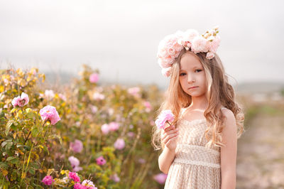 Portrait of cute girl standing at farm