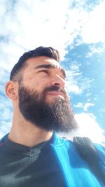 Portrait of young man against sky