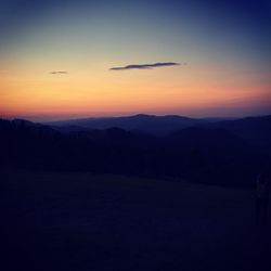 Scenic view of silhouette mountains against sky during sunset