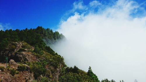 Scenic view of mountains against blue sky