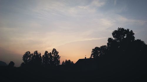 Silhouette trees against sky during sunset