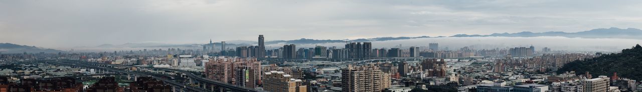 High angle view of cityscape against cloudy sky