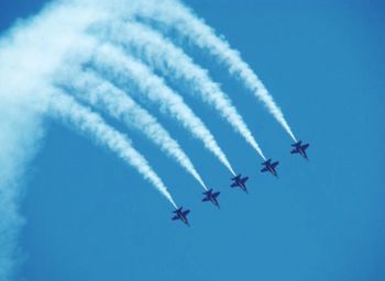 Low angle view of airplane flying in sky