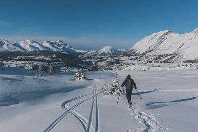 An unrecognizable male hiker wearing snowshoes running in the french alps on a cold winter day