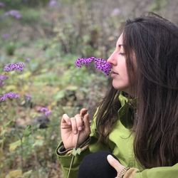 Woman enjoys smelling the newborn flowers