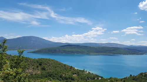 Scenic view of sea and mountains against sky