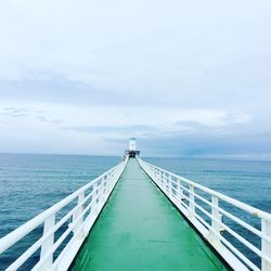 View of pier over calm sea against sky