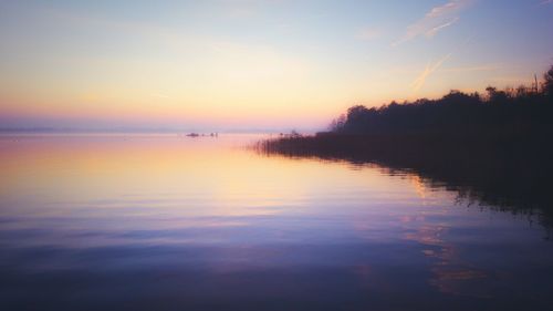 Scenic view of lake at sunset