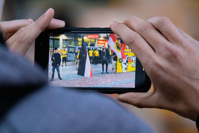 Midsection of man using mobile phone