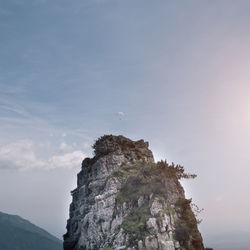 Low angle view of cliff against sky