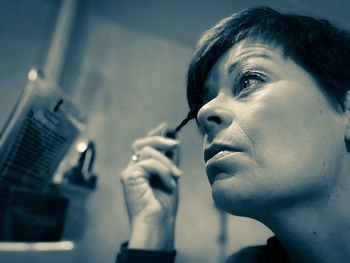 Close-up of woman applying mascara