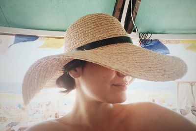 Close-up of woman with sun hat at beach