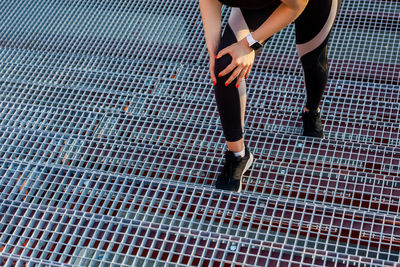 Low section of woman standing on tiled floor