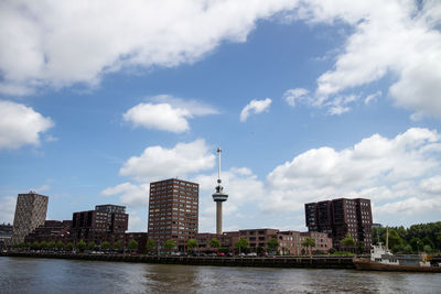 River in city against cloudy sky