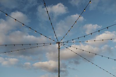 Low angle view of power lines against sky