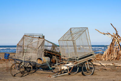 Bicycles on beach against clear sky