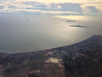 High angle view of buildings by sea against sky